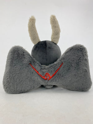 Motthew the Mothman plush by TOTYM, inspired by West Virginia folklore, with fluffy antennae, wings, and glowing red eyes, shown from the back on a white background.