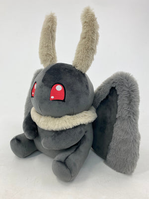 Motthew the Mothman plush by TOTYM, inspired by West Virginia folklore, with fluffy antennae, wings, and glowing red eyes, facing a left angle on a clean white background.