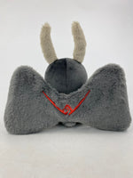 Motthew the Mothman plush by TOTYM, inspired by West Virginia folklore, with fluffy antennae, wings, and glowing red eyes, shown from the back on a white background.